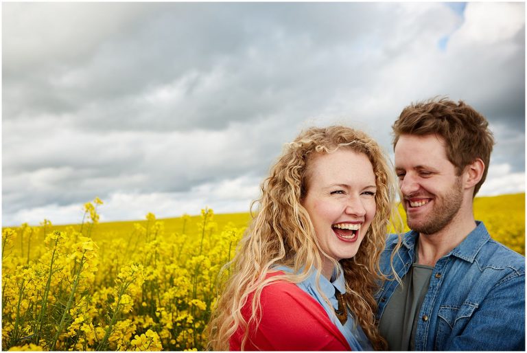 a couple laugh in the countryside