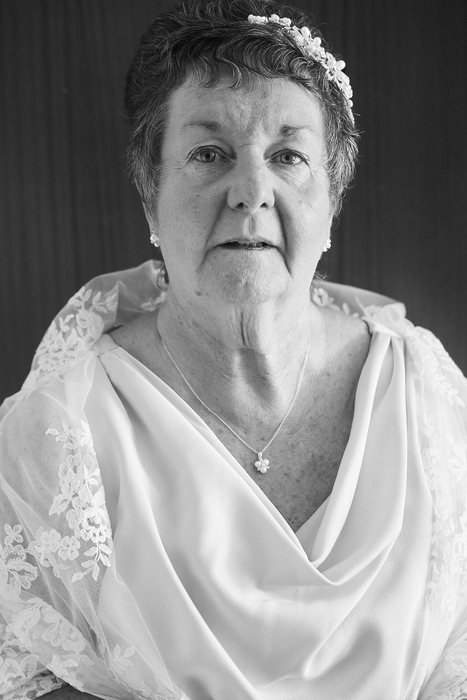 A black and white portrait of an older bride on her wedding day