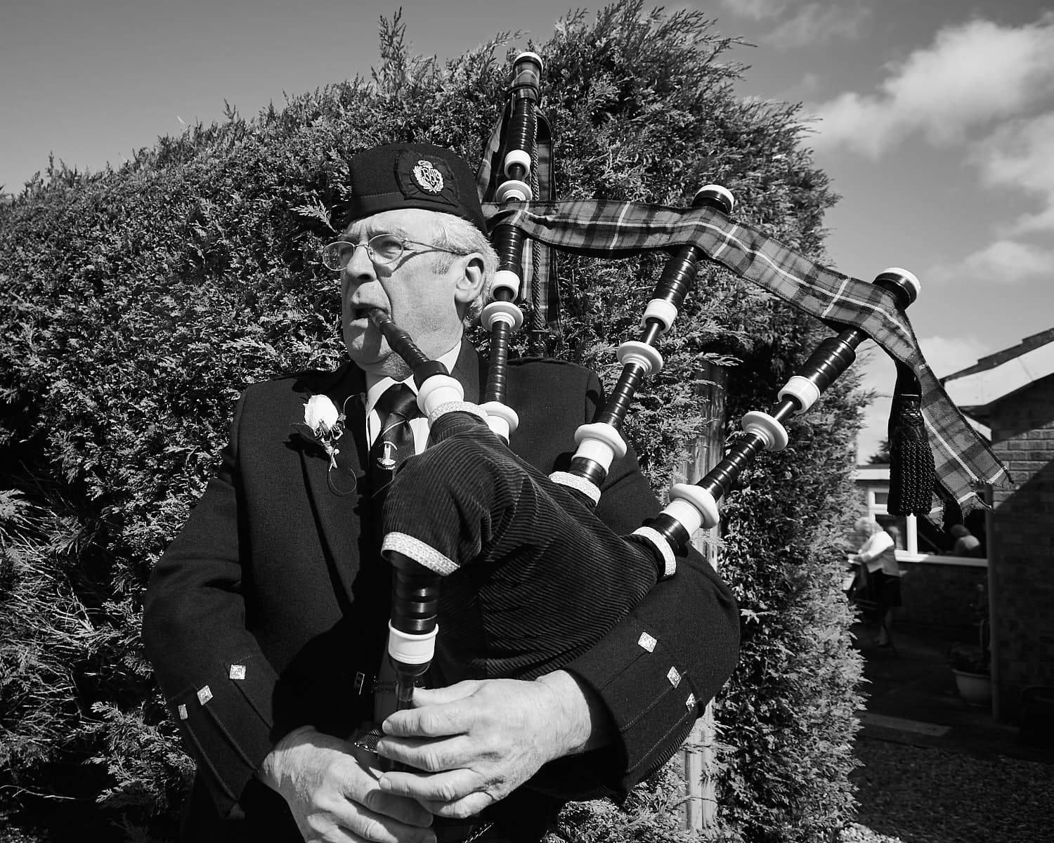 A bagpipe player playing on a wedding day in Lincolnshire