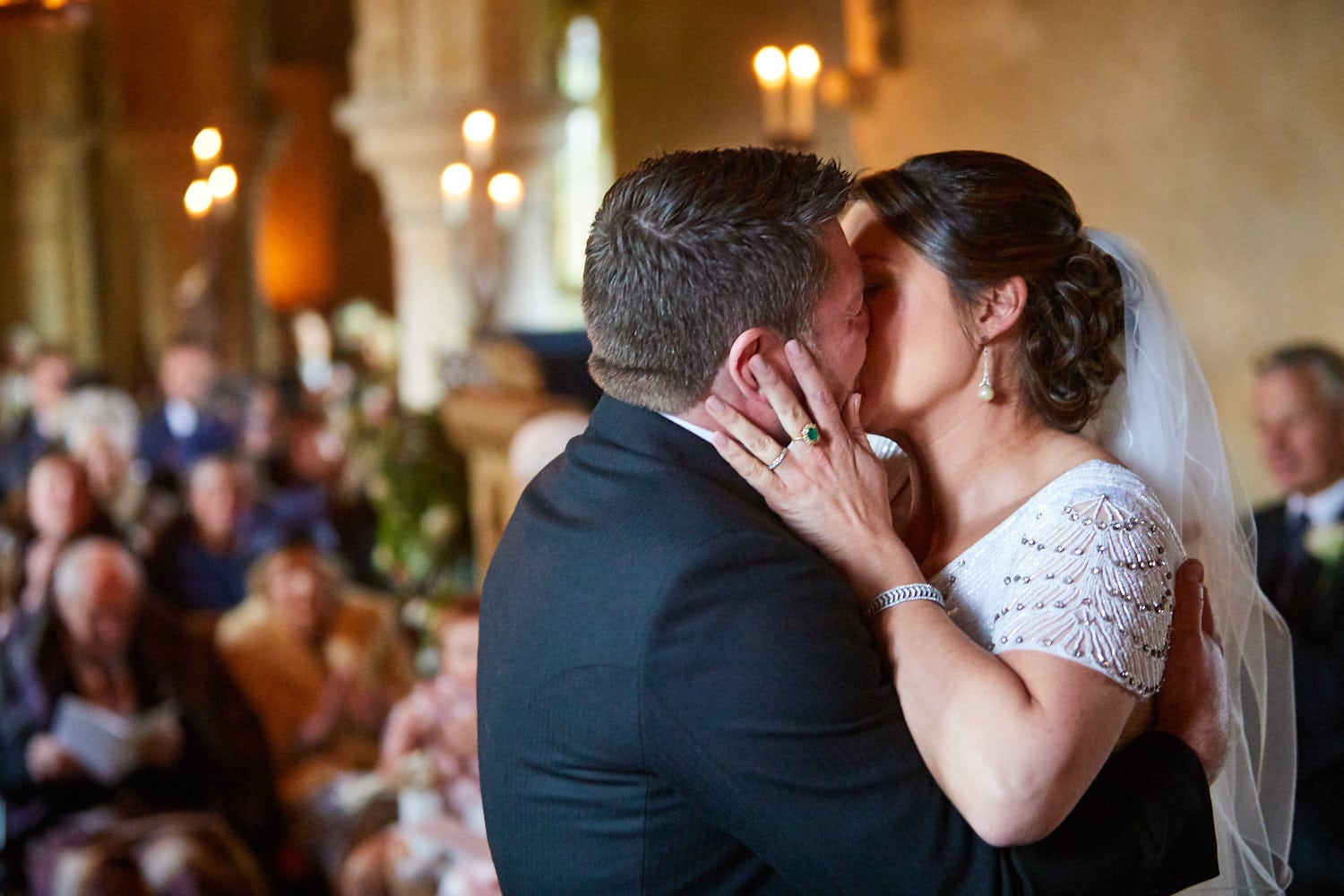 A bride and groom kiss on their wedding day at the Saxon church at Howell Manor, Sleaford.