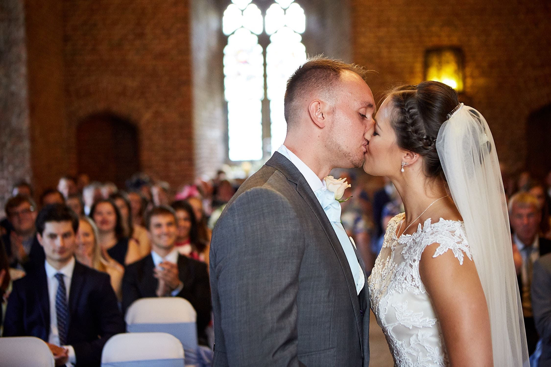 A groom kisses his new wife at the ceremony