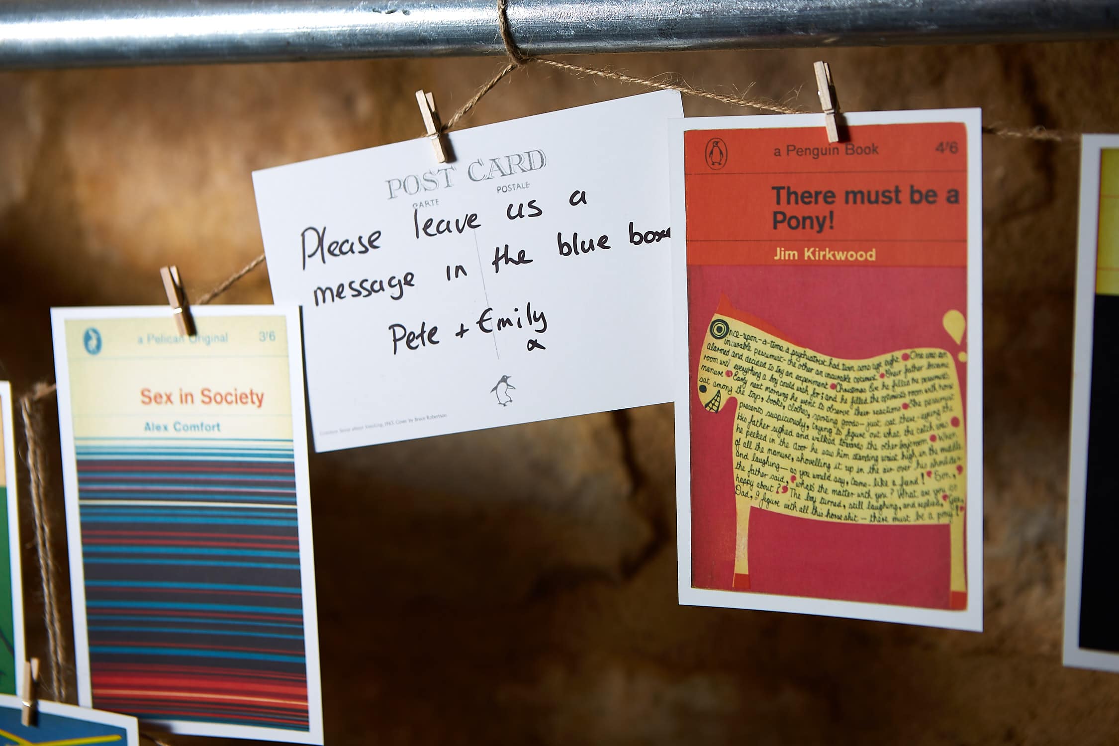 A series of Penguin Book postcards hanging on a wire
