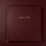 Dark red wedding album with gold text