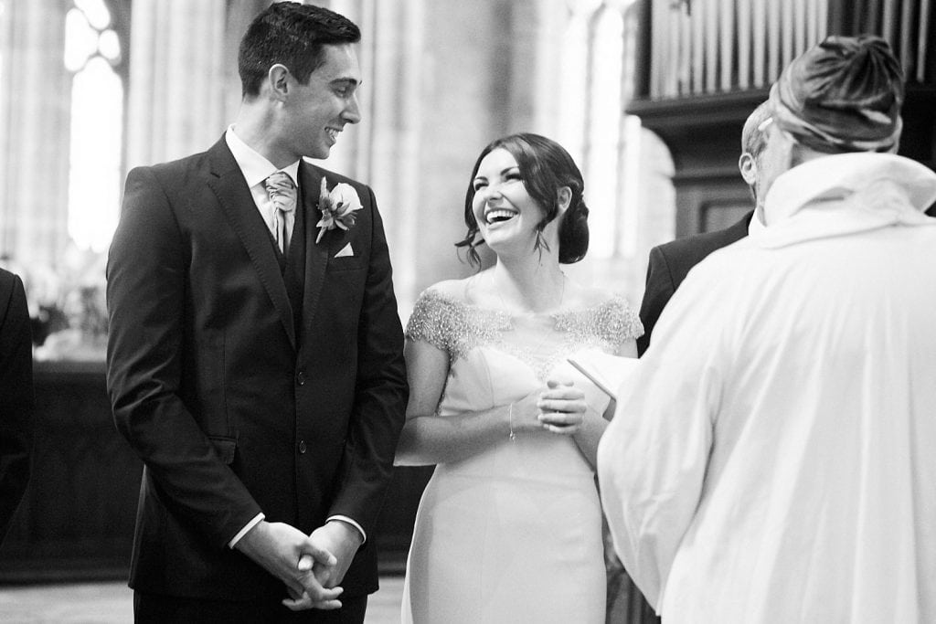 A bride and groom share a joke on their wedding day