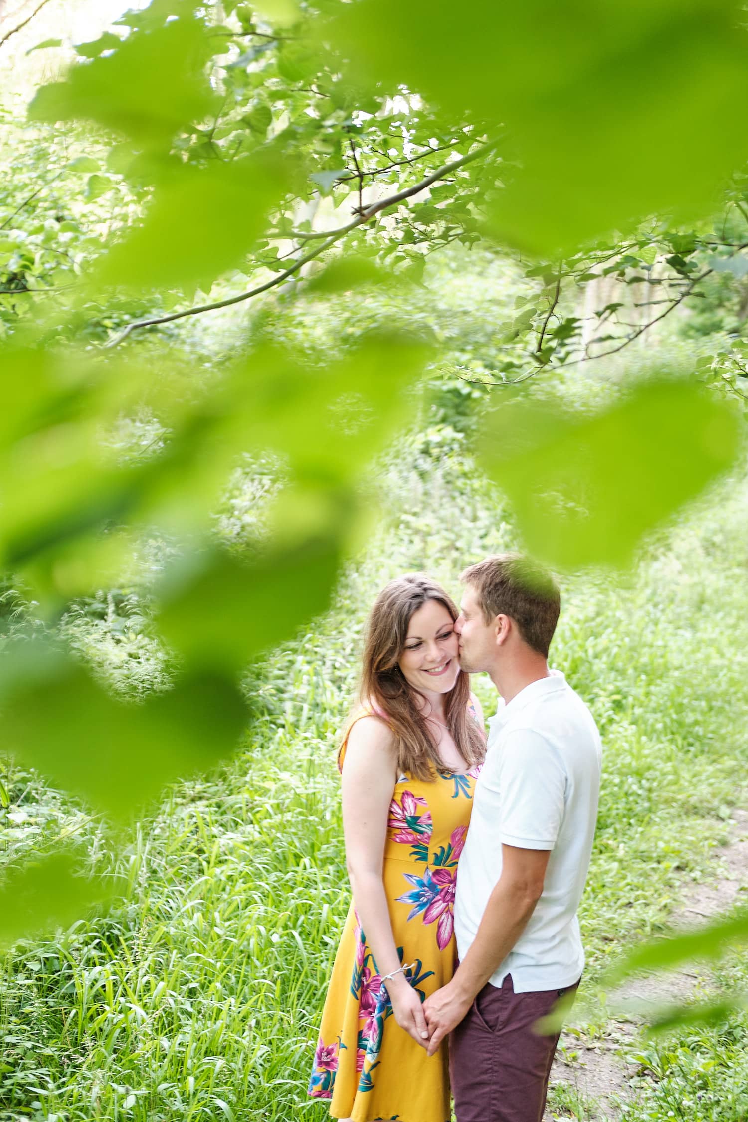 A couple kis sin woodland near Lincoln on their engagement shoot