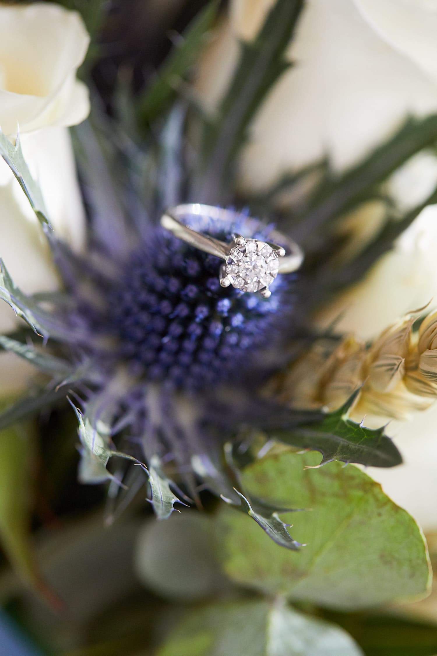 An engagement ring sitting in the brides flowers on her wedding day