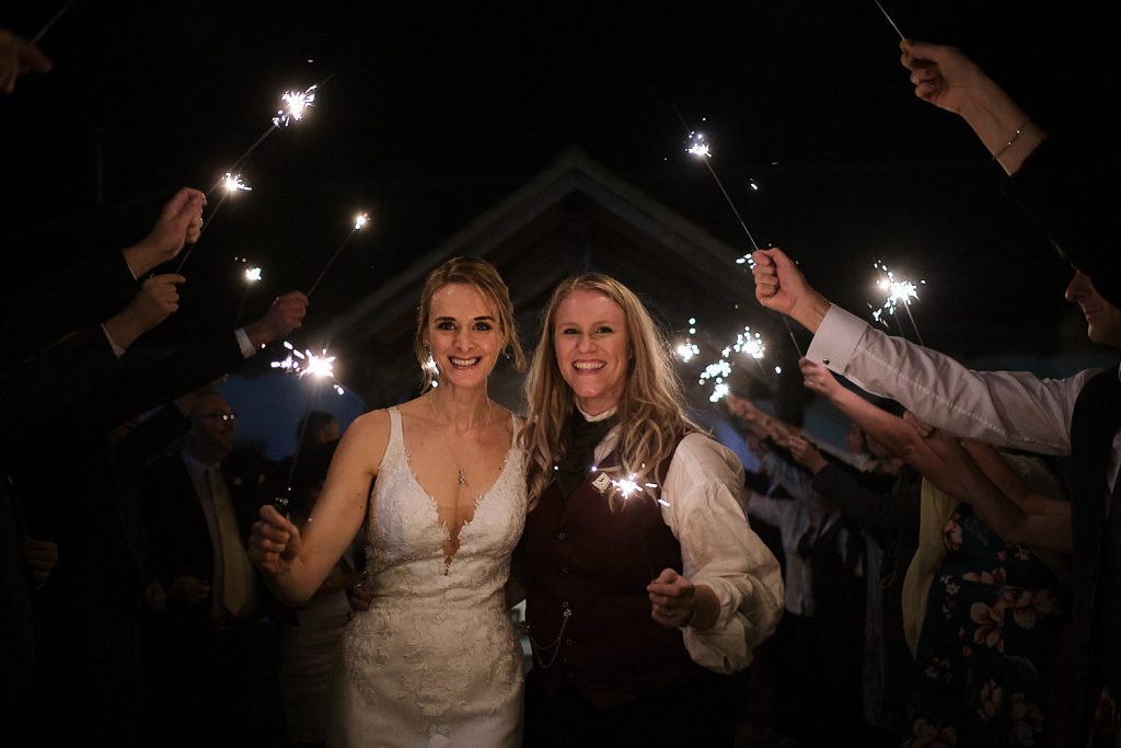 A couple leave Abbey Farm through sparklers