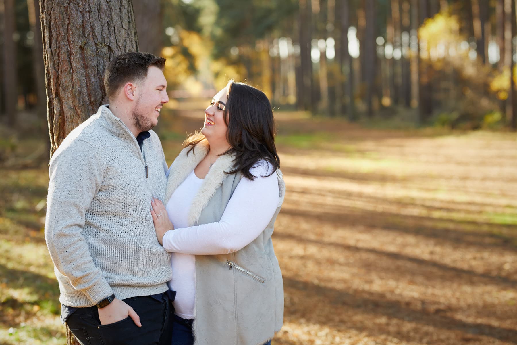 Woodland engagement session with a couple being close