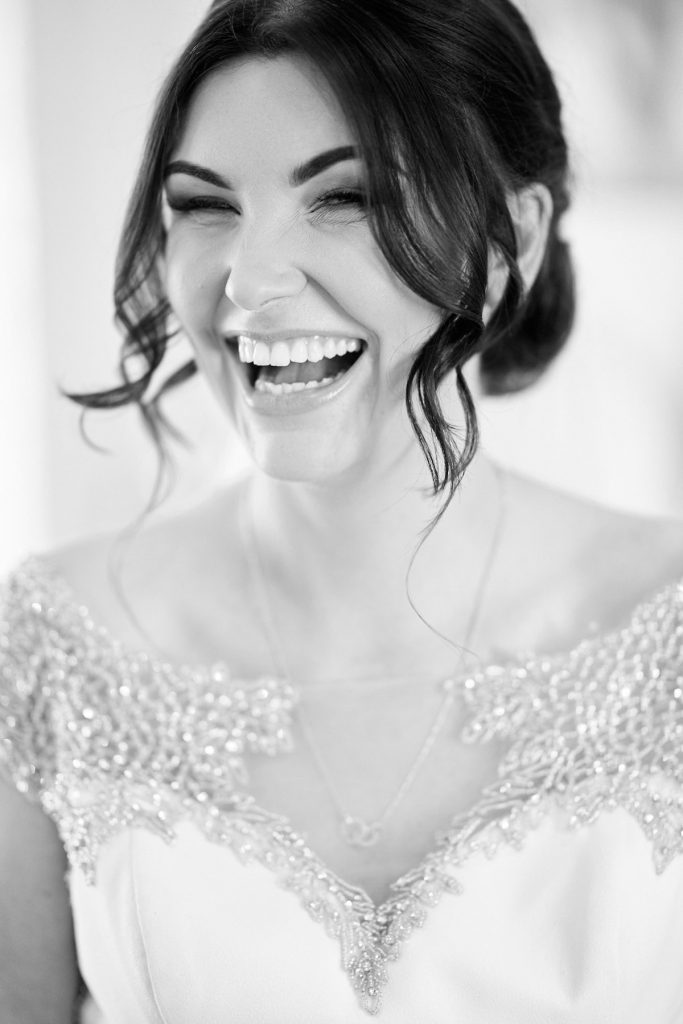 A bride giggles on the morning of her wedding in Sleaford
