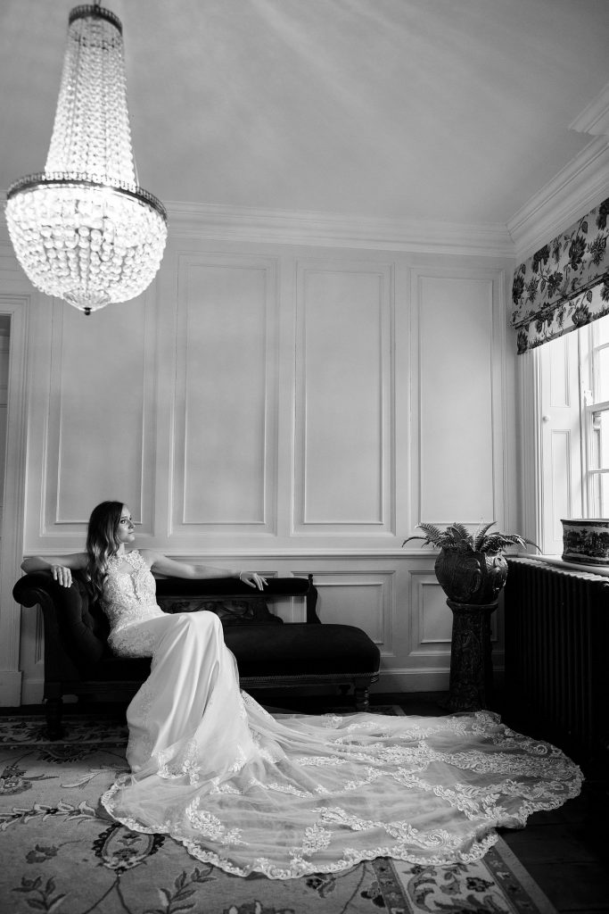 A bride relaxes in the entrance to The Elm Tree Wedding venue in Lincolnshire