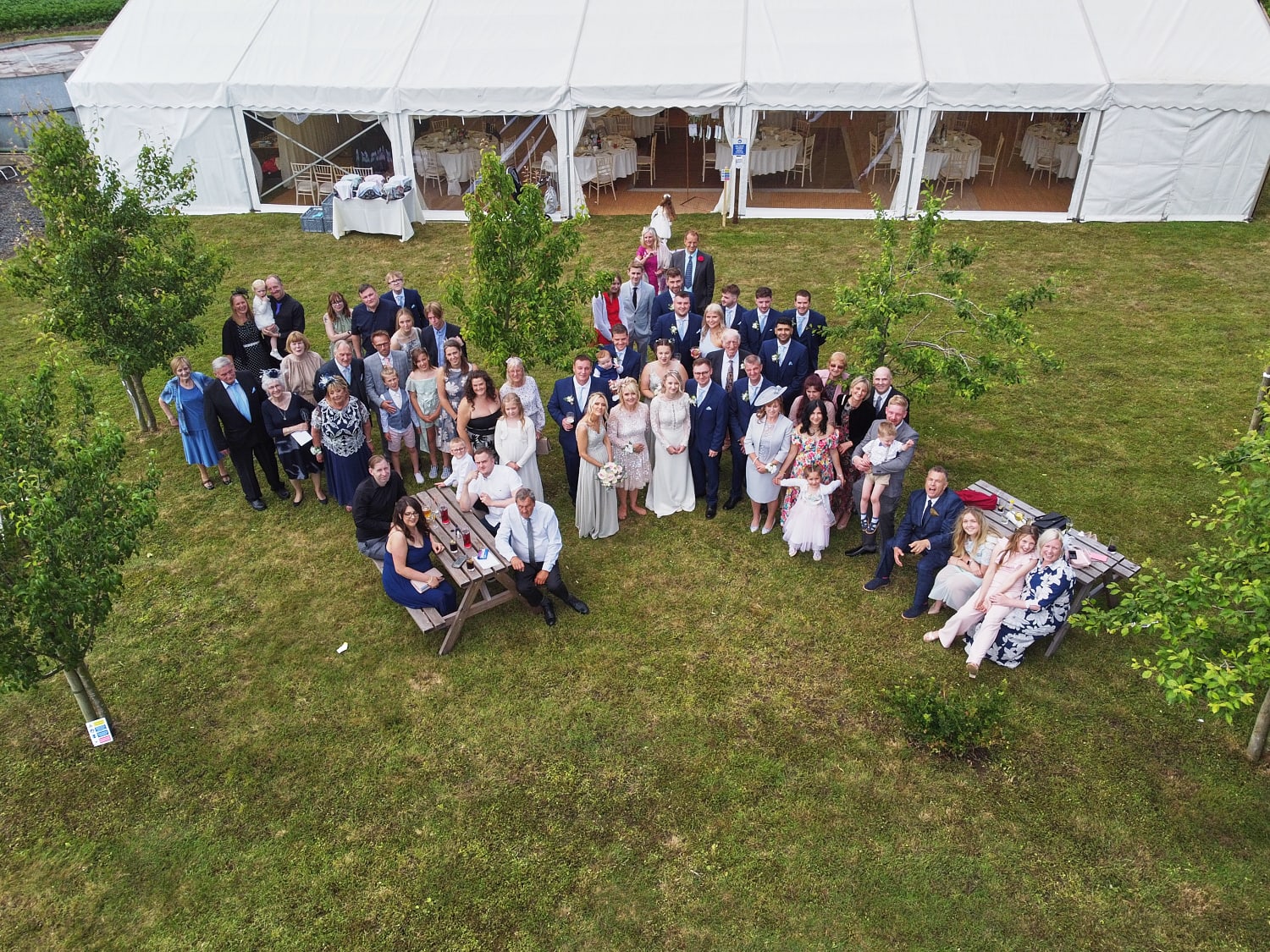 a group photo of a wedding party shot on a deon