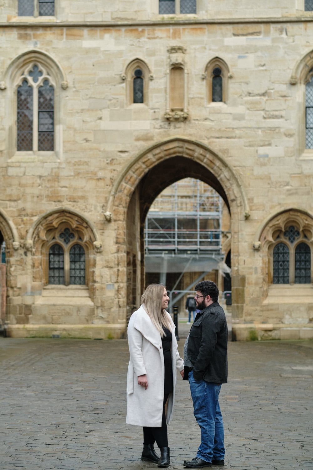 A couple talking during their engagement shoot at Lincoln Cathedral